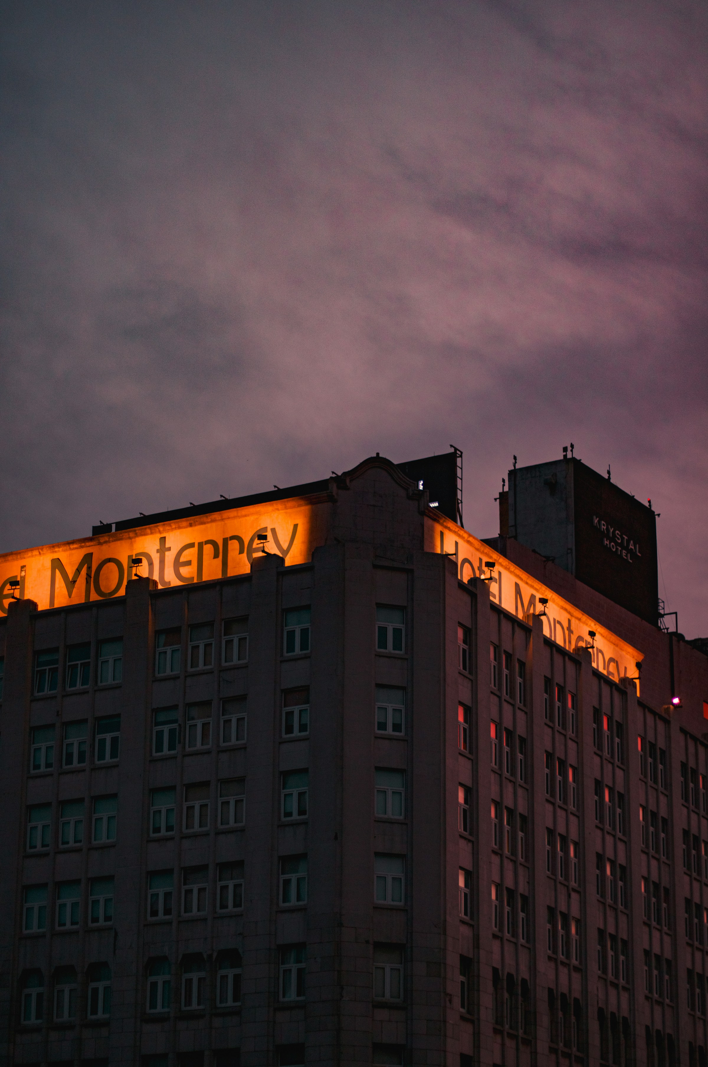 The illuminated Hotel Monterrey signage at dusk in the Centro district