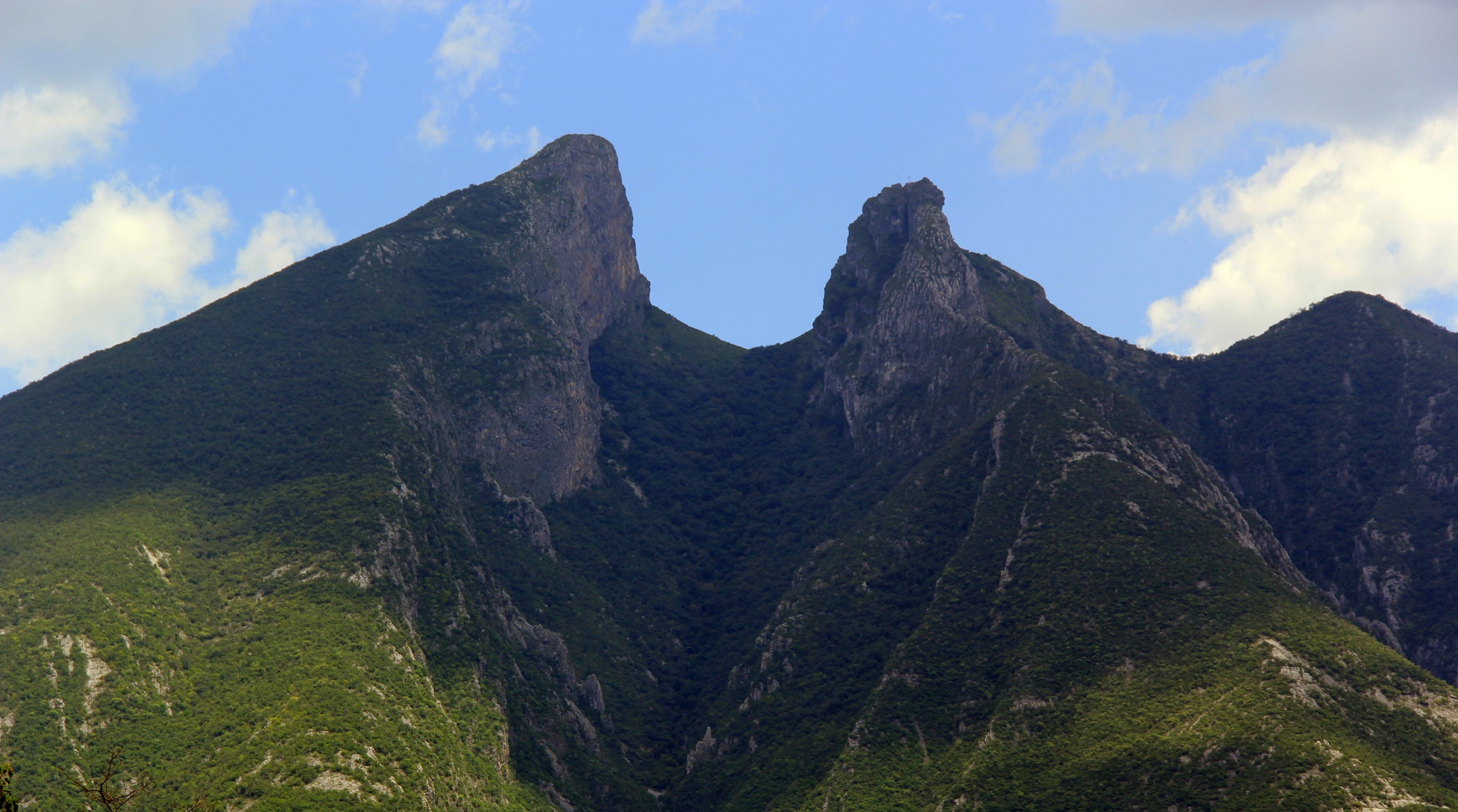 The twin peaks of Cerro de la Silla against a clean blue sky