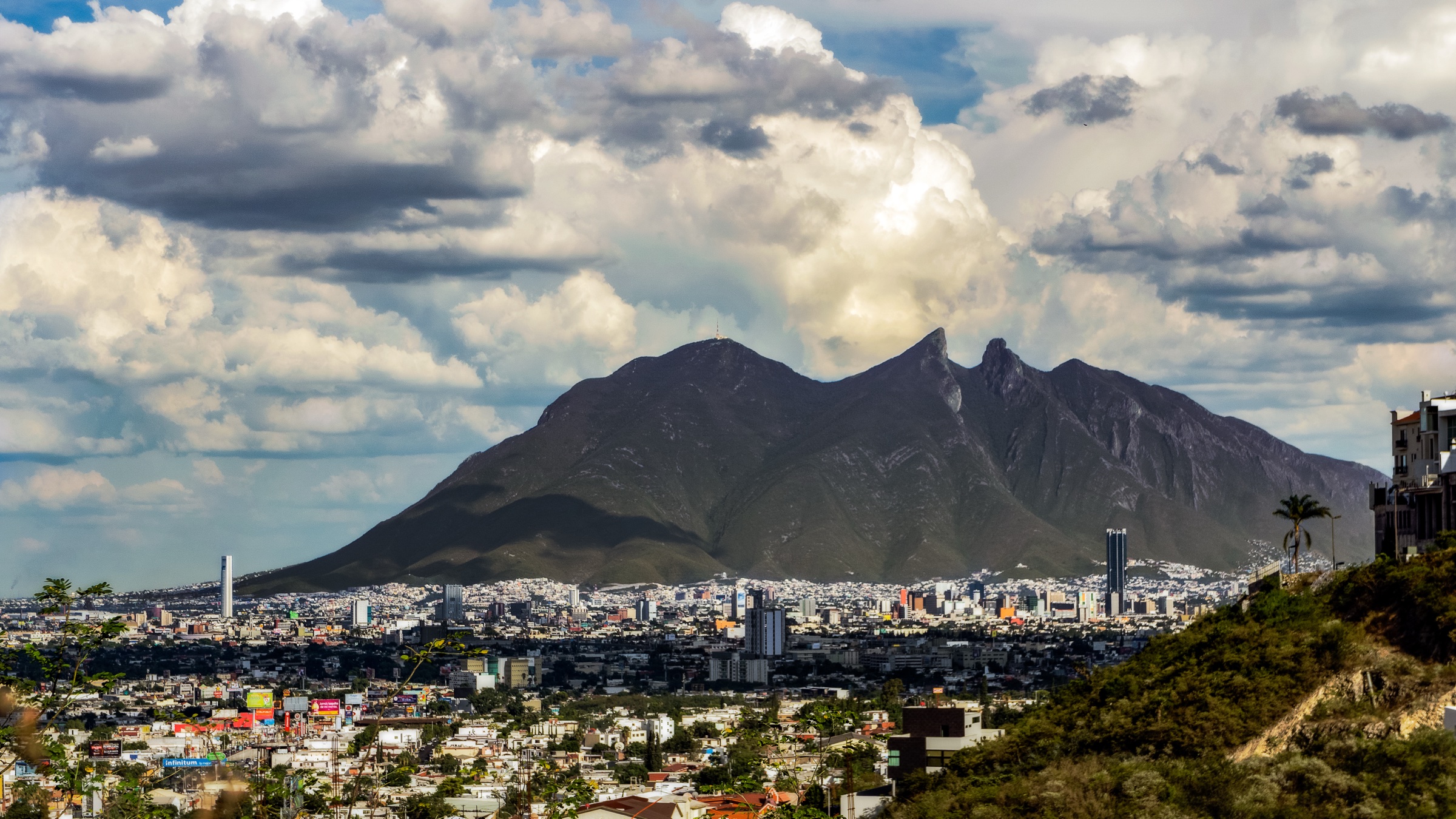 Cerro de la Silla under dramatic cloud cover above Monterrey