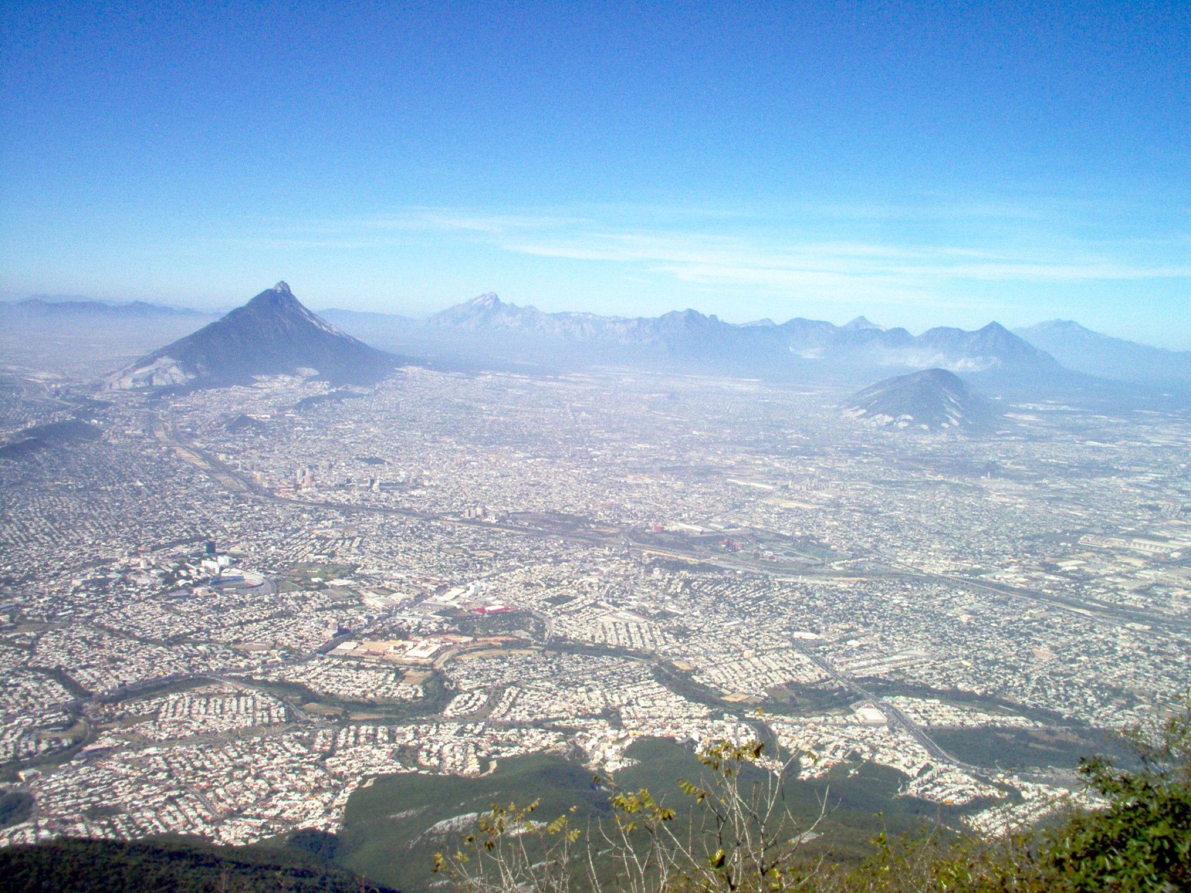 Wide aerial view of Monterrey with the Sierra Madre on the horizon